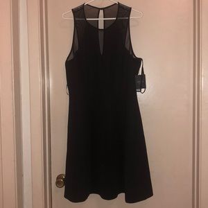 Black dress. With mesh/see-through top/strap